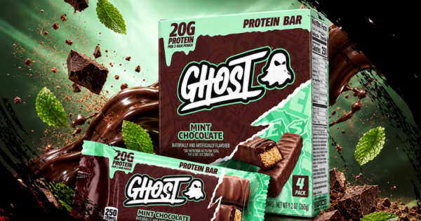 Barra de proteína Ghost Mint Chocolate ao lado de um copo de água e halteres sobre um tapete de treino