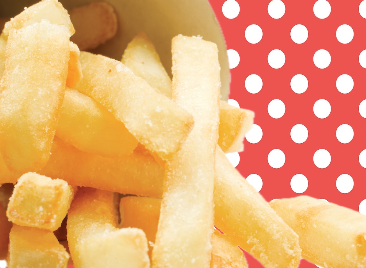 Batatas fritas douradas e crocantes servidas em uma cesta de metal, com foco na textura perfeita e salpicadas de sal