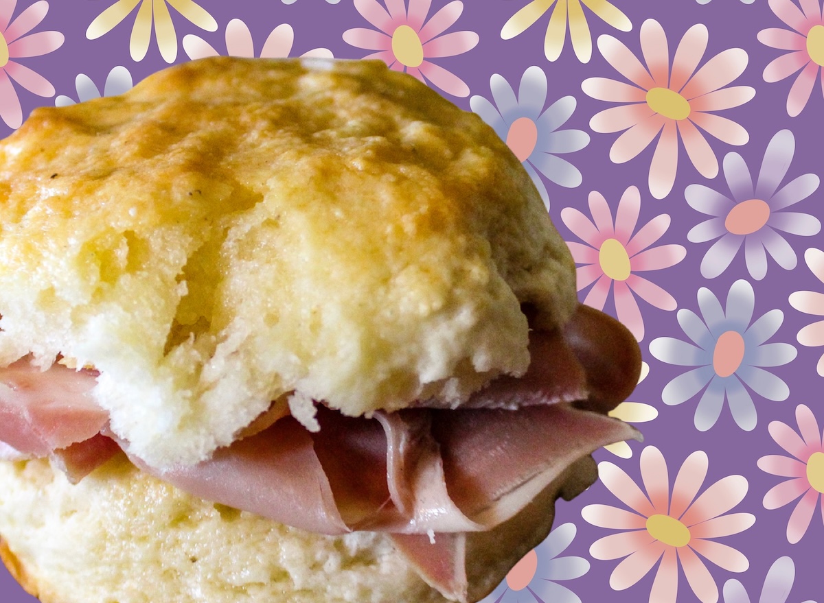 Um biscoito macio de farinha de trigo coberto por uma camada generosa de presunto curado