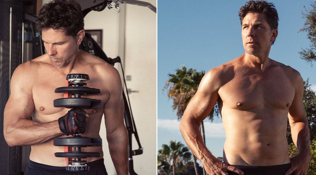 Michael Trucco levanta halteres ao lado de bicicleta ergométrica, vestindo camiseta esportiva e toalha