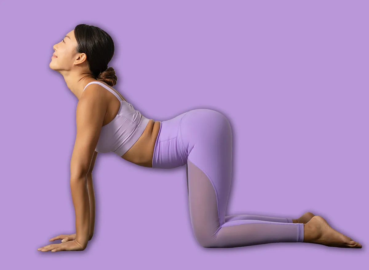 Uma mulher sentada em uma cadeira de exercícios, com um livro de alongamentos aberto ao lado